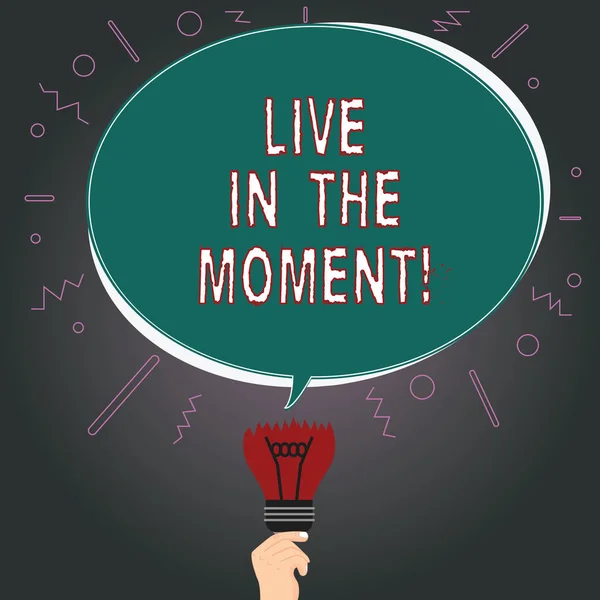 Writing note showing Live In The Moment. Business photo showcasing Be inspired motivated enjoy today happy moments Oval Speech Bubble Above a Broken Bulb with Failed Idea icon.