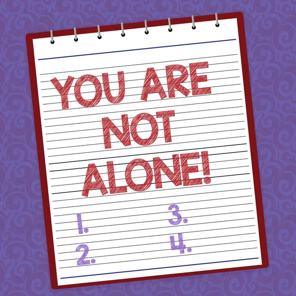 Handwriting text writing You Are Not Alone. Concept meaning Offering help support assistance collaboration company Lined Spiral Top Color Notepad photo on Watermark Printed Background.