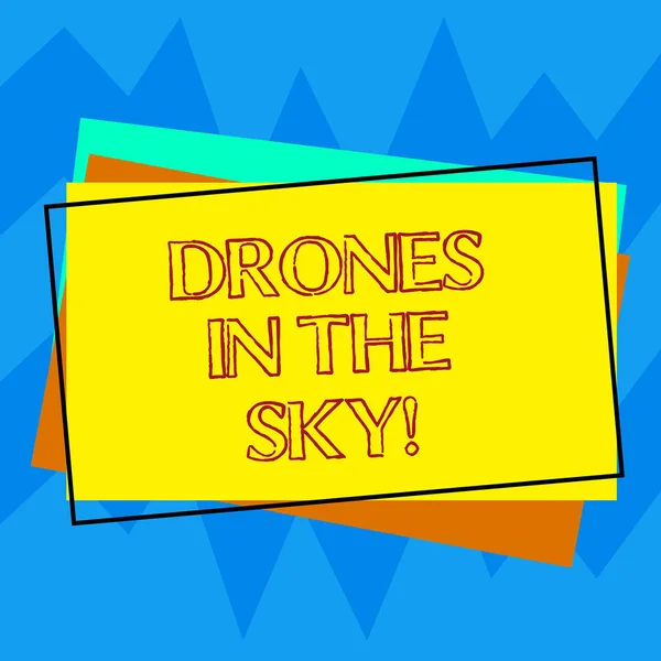 Handwriting text writing Drones In The Sky. Concept meaning Aerial helicopter modern device taking pictures and video Pile of Blank Rectangular Outlined Different Color Construction Paper.
