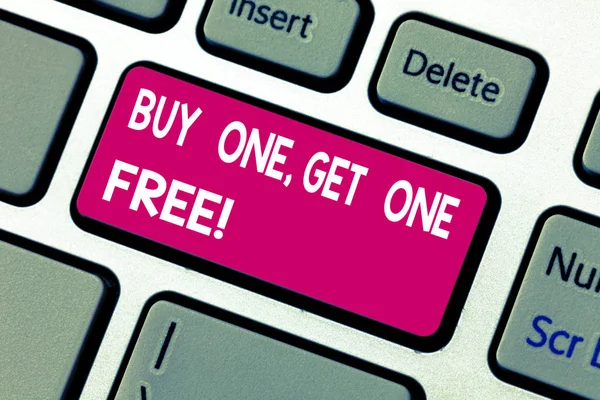 Text sign showing Buy One Get One Free. Conceptual photo Promotion discount special offering in gift card Keyboard key Intention to create computer message pressing keypad idea.