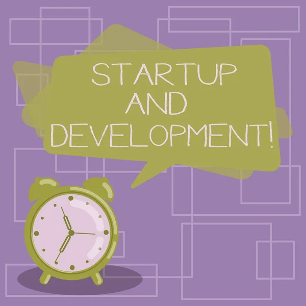 Text sign showing Startup And Development. Conceptual photo search for a repeatable and scalable business model Blank Rectangular Color Speech Bubble Overlay and Analog Alarm Clock. — 图库照片