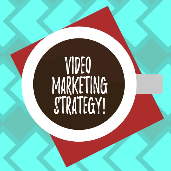 Text sign showing Video Marketing Strategy. Conceptual photo integrates engaging video into marketing campaigns Top View of Drinking Cup Filled with Beverage on Color Paper photo. — Stock Photo, Image
