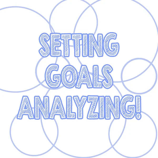 Handwriting text writing Setting Goals Analyzing. Concept meaning Helped to be realistic about what can really achieve Outlines of Round Shape in Different Size Circle Loop Ring Hoop photo.