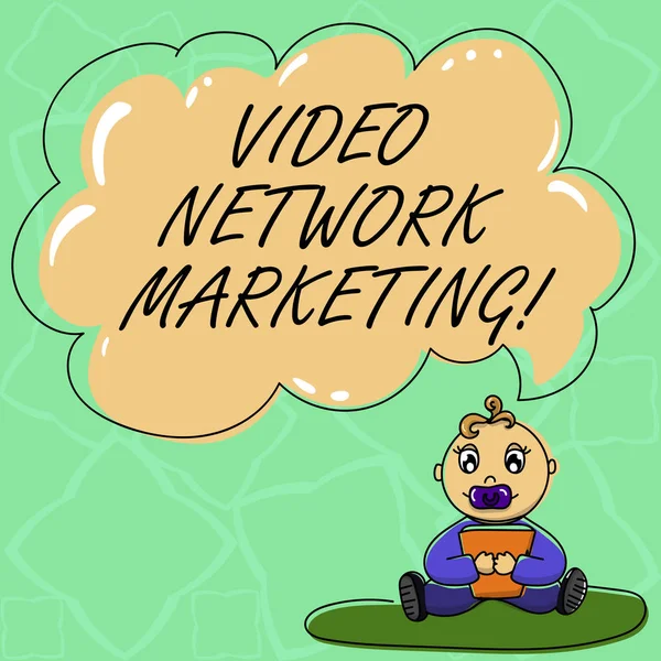 Word writing text Video Network Marketing. Business concept for Engaging video into your marketing campaign Baby Sitting on Rug with Pacifier Book and Blank Color Cloud Speech Bubble.