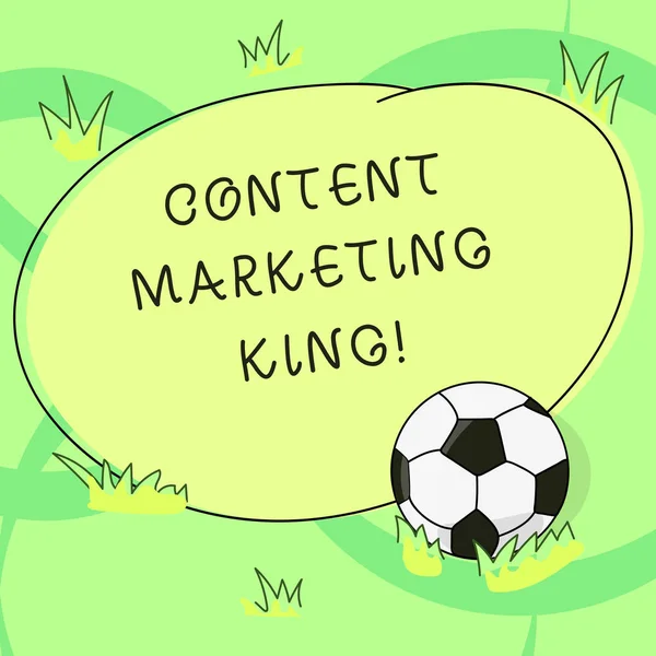 Writing note showing Content Marketing King. Business photo showcasing Content is central to the success of a website Soccer Ball on the Grass and Blank Outlined Round Color Shape photo.