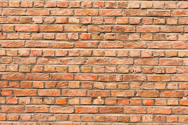 red brick wall texture grunge background with vignetted corners, may use to interior design. Old orange brick