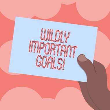 Writing note showing Wildly Important Goals. Business photo showcasing most important objective that needs special attention Drawn Hu analysis Hand Holding Blank Color Paper Cardboard. clipart