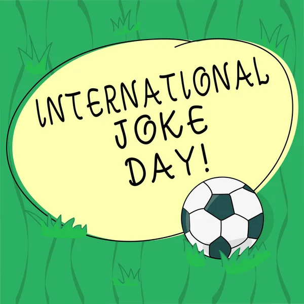 Word writing text International Joke Day. Business concept for holiday to celebrate the benefit of good humor Soccer Ball on the Grass and Blank Outlined Round Color Shape photo.