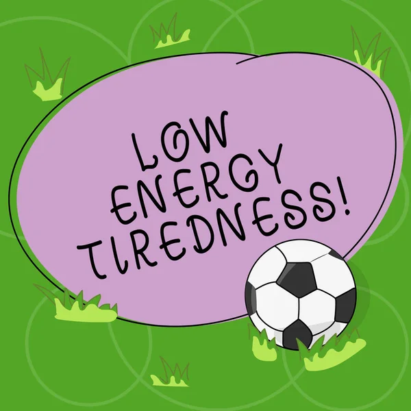 Word writing text Low Energy Tiredness. Business concept for subjective feeling of tiredness that has gradual onset Soccer Ball on the Grass and Blank Outlined Round Color Shape photo. — Stock Photo, Image