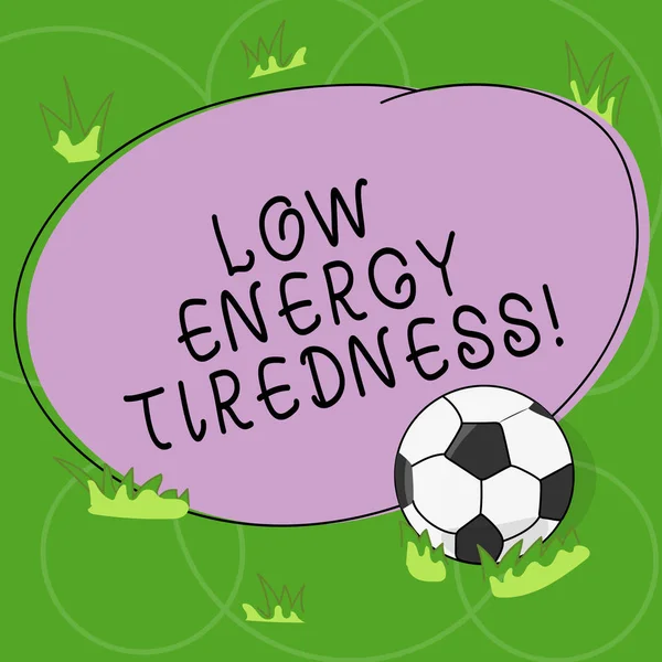 Word writing text Low Energy Tiredness. Business concept for subjective feeling of tiredness that has gradual onset Soccer Ball on the Grass and Blank Outlined Round Color Shape photo.