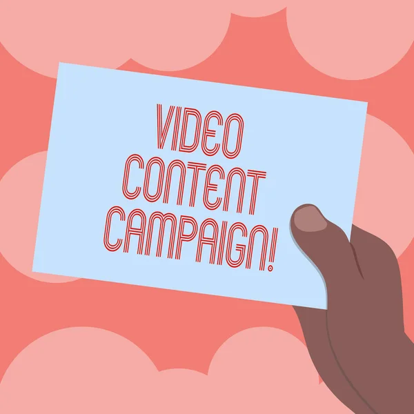 Writing note showing Video Content Campaign. Business photo showcasing Integrates engaging video into marketing campaigns Drawn Hu analysis Hand Holding Blank Color Paper Cardboard.