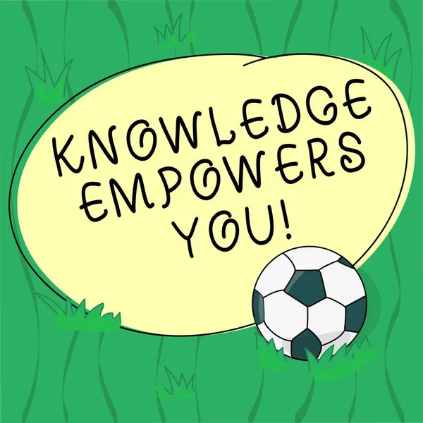 Word writing text Knowledge Empowers You. Business concept for To equip someone with skills and knowledge to do task Soccer Ball on the Grass and Blank Outlined Round Color Shape photo.