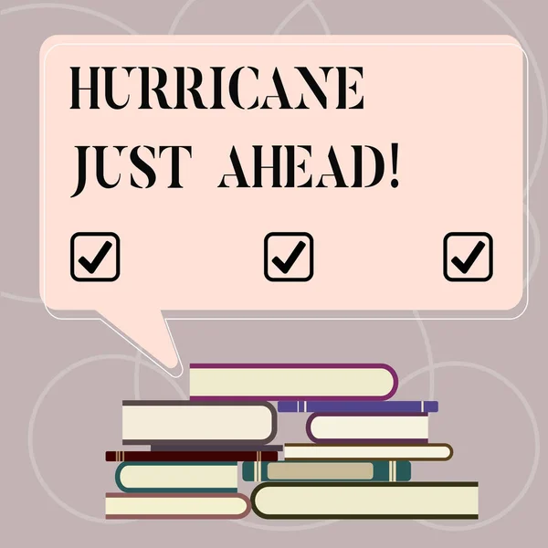 Word writing text Hurricane Just Ahead. Business concept for violent tropical cyclone is approaching to hit the land Uneven Pile of Hardbound Books and Blank Rectangular Color Speech Bubble.