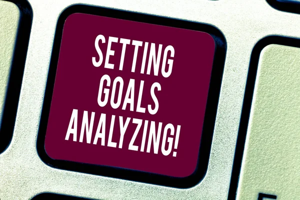 Text sign showing Setting Goals Analyzing. Conceptual photo Helped to be realistic about what can really achieve Keyboard key Intention to create computer message pressing keypad idea.