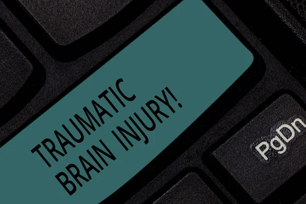 Handwriting text Traumatic Brain Injury. Concept meaning Insult to the brain from an external mechanical force Keyboard key Intention to create computer message pressing keypad idea.