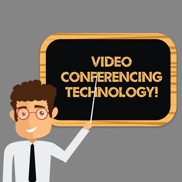 Text sign showing Video Conferencing Technology. Conceptual photo People globally interacted through video data Man Standing Holding Stick Pointing to Wall Mounted Blank Color Board.