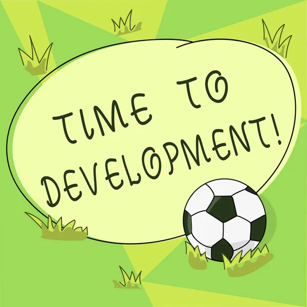 Conceptual hand writing showing Time To Development. Business photo showcasing length of time during which company grows improve Soccer Ball on the Grass and Blank Round Color Shape photo.