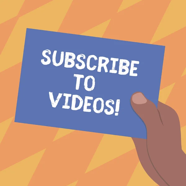 Text sign showing Subscribe To Videos. Conceptual photo like to see more content from those channels pages Drawn Hu analysis Hand Holding Presenting Blank Color Paper Cardboard photo.