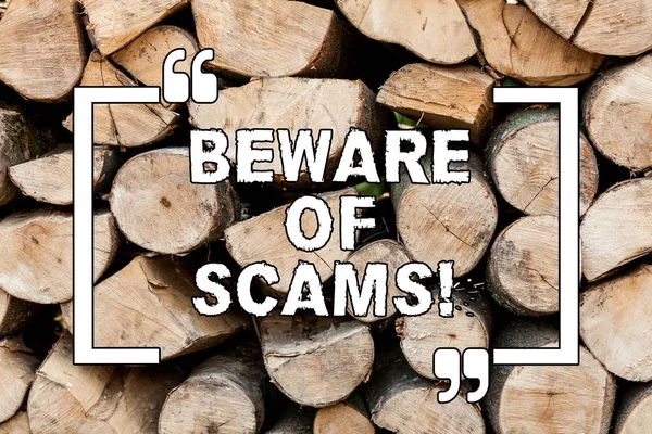 Handwriting text writing Beware Of Scams. Concept meaning Stay alert to avoid fraud caution be always safe security Wooden background vintage wood wild message ideas intentions thoughts.