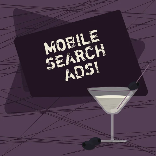 Conceptual hand writing showing Mobile Search Ads. Business photo showcasing ad that can appear on webpages and apps viewed on phone Filled Cocktail Wine Glass with Olive on the Rim Text Space.