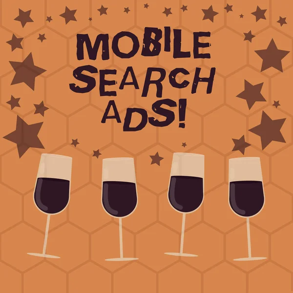 Writing note showing Mobile Search Ads. Business photo showcasing ad that can appear on webpages and apps viewed on phone Filled Cocktail Wine Glasses with Scattered Stars as Confetti Stemware.