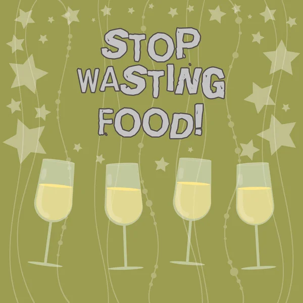Text sign showing Stop Wasting Food. Conceptual photo organization works for reduction food waste in society Filled Cocktail Wine Glasses with Scattered Stars as Confetti Stemware.