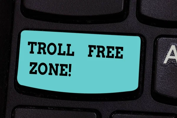 Handwriting text Troll Free Zone. Concept meaning Social network where tolerance and good behavior is a policy Keyboard key Intention to create computer message pressing keypad idea.