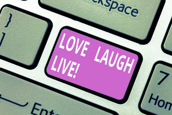 Text sign showing Love Laugh Live. Conceptual photo Be inspired positive enjoy your days laughing good humor Keyboard key Intention to create computer message pressing keypad idea.