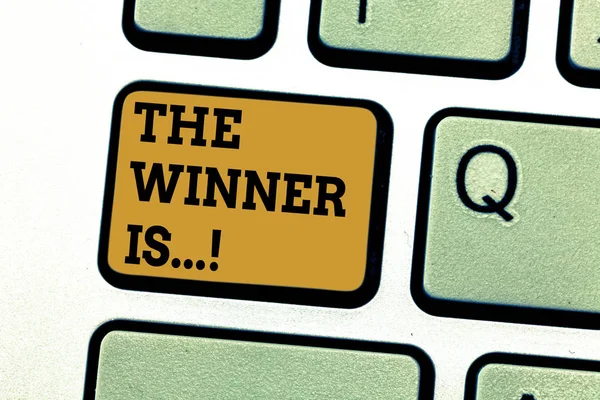 Text sign showing The Winner Is . Conceptual photo Announcing who won a contest Victory on a competition Keyboard key Intention to create computer message pressing keypad idea. — Stock Photo, Image