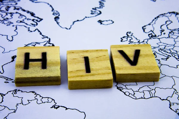 The word HIV written with wooden letters blocks above map. Health concept with word HIV. — Stock Photo, Image