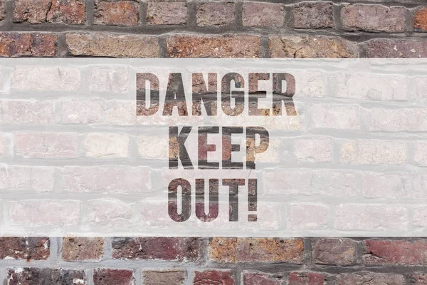 Writing note showing Danger Keep Out. Business photo showcasing Warning be alert stay away from this point safety sign Brick Wall art like Graffiti motivational call written on the wall.