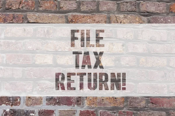 Writing note showing File Tax Return. Business photo showcasing Paperwork to get financial money returning accountant job Brick Wall art like Graffiti motivational call written on the wall.