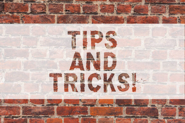 Handwriting text writing Tips And Tricks. Concept meaning Steps Life hacks Handy advice Recommendations Skills Brick Wall art like Graffiti motivational call written on the wall.