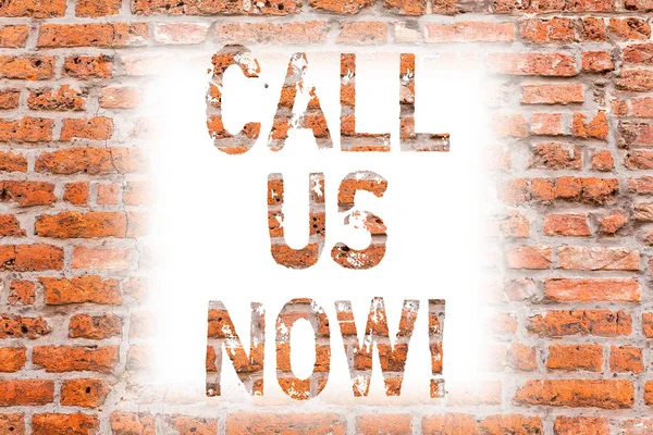 Text sign showing Call Us Now. Conceptual photo Communicate by telephone to contact help desk support assistance Brick Wall art like Graffiti motivational call written on the wall.