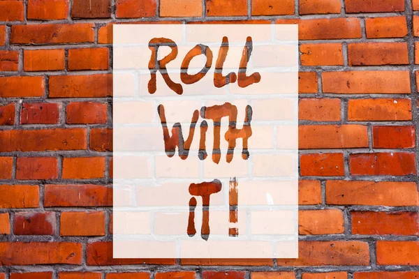Handwriting text writing Roll With It. Concept meaning Going along with things without having high expectations Brick Wall art like Graffiti motivational call written on the wall.