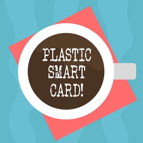 Conceptual hand writing showing Plastic Smart Card. Business photo showcasing security token that has embedded intelligent chip Top View of Drinking Cup Filled with Beverage on Color Paper.