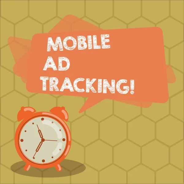 Conceptual hand writing showing Mobile Ad Tracking. Business photo text monitor brand perforanalysisce including advertising awareness Rectangular Speech Bubble Overlay and Analog Alarm Clock.