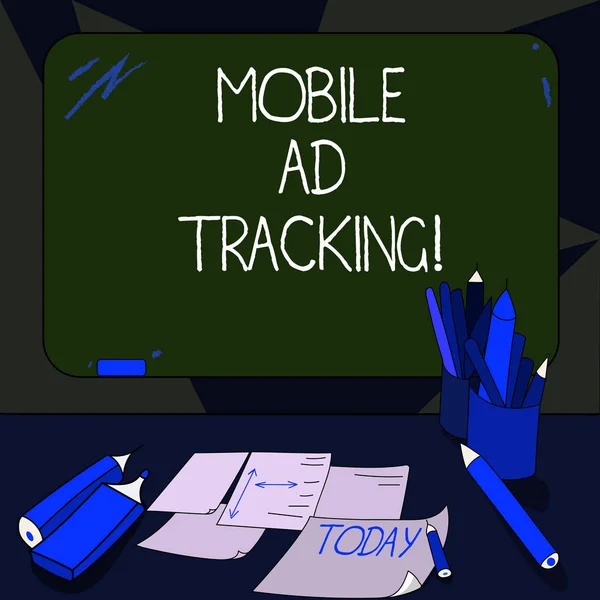 Handwriting text writing Mobile Ad Tracking. Concept meaning monitor brand perforanalysisce including advertising awareness Mounted Blank Color Blackboard with Chalk and Writing Tools Sheets on Desk.