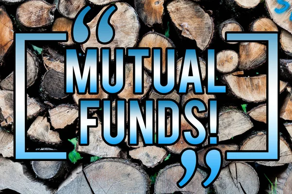 Word writing text Mutual Funds. Business concept for Investment Strategy to purchase shares with other investors Wooden background vintage wood wild message ideas intentions thoughts.