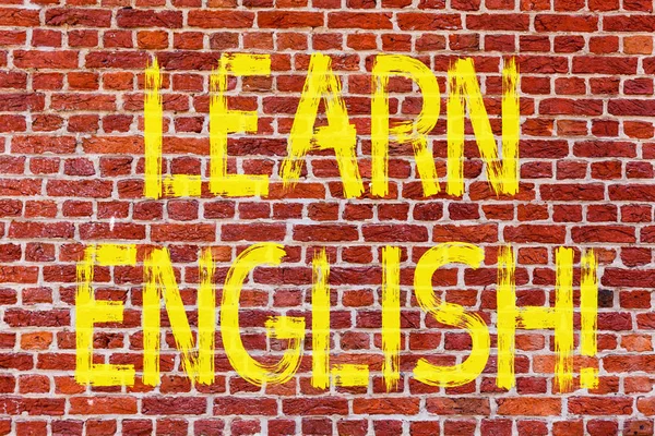 Writing note showing Learn English. Business photo showcasing Study another Language Learn Something Foreign Communication Brick Wall art like Graffiti motivational call written on the wall.