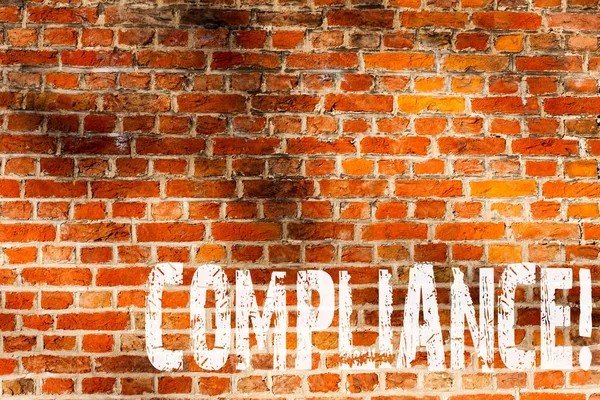 Word writing text Compliance. Business concept for Technology Company sets its policy standard regulations Brick Wall art like Graffiti motivational call written on the wall.