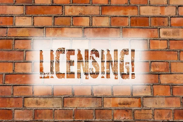 Writing note showing Licensing. Business photo showcasing Grant a license Legally permit the use of something Allow activity Brick Wall art like Graffiti motivational call written on the wall.
