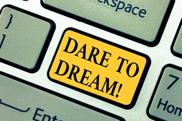 Text sign showing Dare To Dream. Conceptual photo Do not be afraid of have great ambitions goals objectives Keyboard key Intention to create computer message pressing keypad idea.