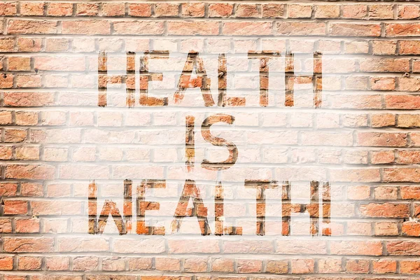 Text sign showing Health Is Wealth. Conceptual photo being in good shape great value Stay healthy eat Healthy Brick Wall art like Graffiti motivational call written on the wall.