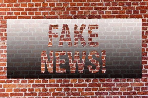 Word writing text Fake News. Business concept for False Unsubstantiated Information Hoax Brick Wall art like Graffiti motivational call written on the wall.