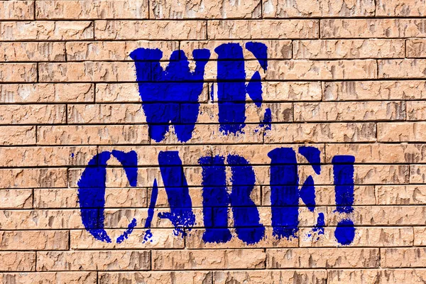 Handwriting text We Care. Concept meaning Give People Help Attention Support Assistance Brick Wall art like Graffiti motivational call written on the wall.