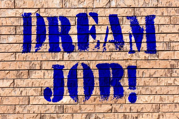 Handwriting text Dream Job. Concept meaning To work in what you like Fulfilling activities Brick Wall art like Graffiti motivational call written on the wall.