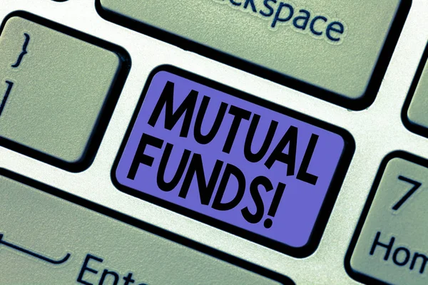 Handwriting text writing Mutual Funds. Concept meaning Investment Strategy to purchase shares with other investors Keyboard key Intention to create computer message pressing keypad idea.