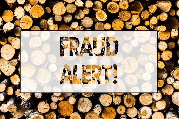 Handwriting text Fraud Alert. Concept meaning Security Message Fraudulent activity suspected Wooden background vintage wood wild message ideas intentions thoughts.