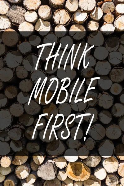 Writing note showing Think Mobile First. Business photo showcasing Handheld devises marketing target portable phones first Wooden background vintage wood wild message ideas intentions thoughts.